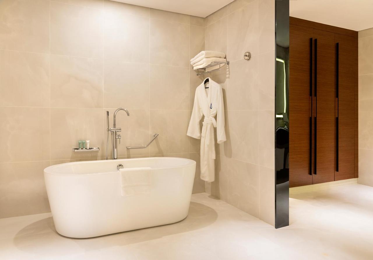 Asiana Grand Hotel Дубай Екстериор снимка A freestanding bathtub